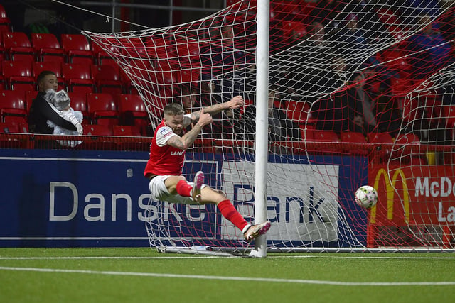 Larne's Andy Ryan doesn't let almost colliding with the post stop him from scoring Larne's only goal - and his sixth in seven matches - against Ballymena United on Friday night.
