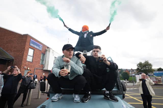 Members of Kneecap arrive at the Belfast premiere of their movie atop a converted RUC land rover in August 2024. Photo by Kelvin Boyes / Press Eye.
