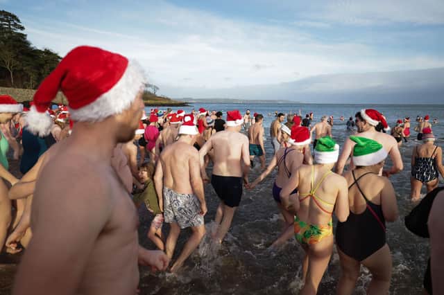 The milder weather made it slightly easier for swimmers who took part in the annual Helens Bay Christmas Eve dip at Helens Bay beach, Co Down. The event also raised funds for PIPS Suicide Prevention and East Belfast Survivors of Suicide.  Photo by Kelvin Boyes / Press  Eye
:-