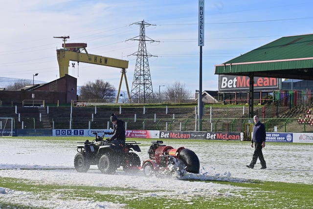 Volunteers trying to clear the snow on The Oval pitch in attempts to get Glentoran vs Glenavon - which was originally scheduled for Friday night - on. The game was ultimately suspended and played at 3pm the following day.