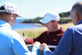 Northern Ireland's Rory McIlroy signs autographs for fans on the 13th tee during the Pro-Am prior to the Genesis Scottish Open at The Renaissance Club. (Photo by Stephen Pond/Getty Images)