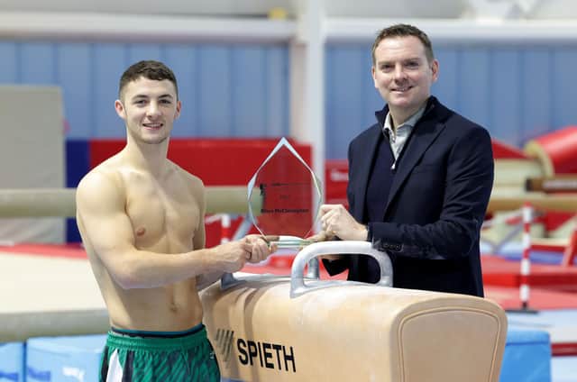 Rhys McClenaghan is presented with the 2022 BBC Northern Ireland Sports Personality of the Year award by BBC Sport NI’s Thomas Kane