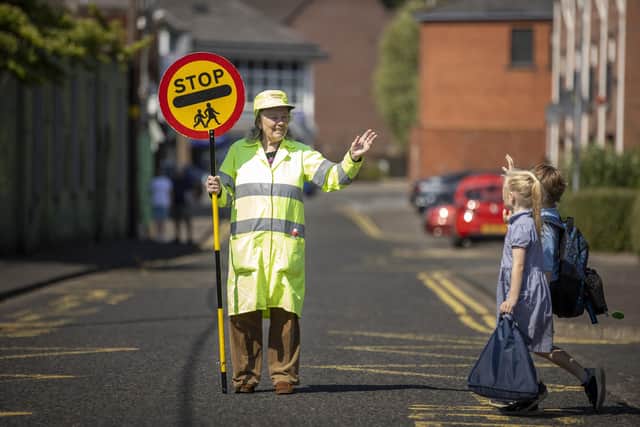 Lollipop lady Veronica Hammersley, 93, who works on the school crossing patrol at Glengormley Integrated Primary School in Northern Ireland, has been awarded the BEM (British Empire Medal), for services to the community in Glengormley, County Antrim, in the King's Birthday Honours list