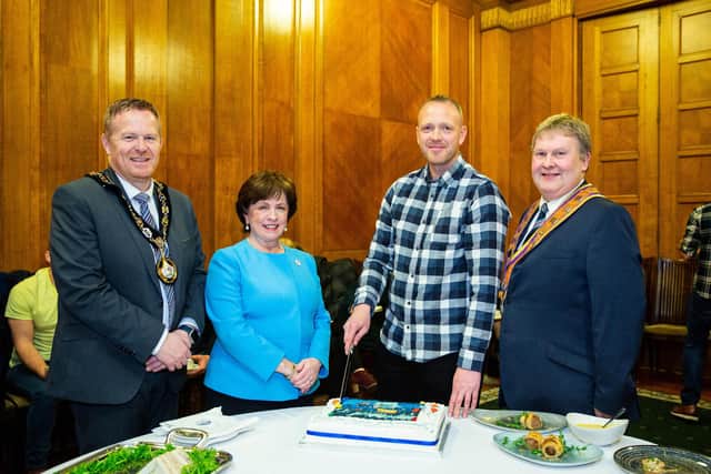 Cutting a cake to celebrate the achievement of the Hiking Orangemen are; The Lord Mayor of Armagh City, Banbridge and Craigavon Borough Council, Cllr Paul Greenfield; Upper Bann DUP MLA, Diane Dodds; Wor. Bro. Stuart Magill; and Deputy Grand Master Wor. Bro. Harold Henning. (Photo by Graham Baalham-Curry)