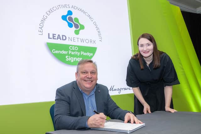 Noel Keeley CEO Musgrave Group with Eileen Biggs, talent and resourcing partner signing the LEAD pledge