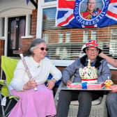 Baker Margaret Smith, Jim Dunwoody (92), the last surviving member of his battalion who fought in the Korean war, and his son Jimmy enjoying the Coronation Big Lunch at Rainbow Alley in East Belfast. Pic: Arthur Allison/Pacemaker Press