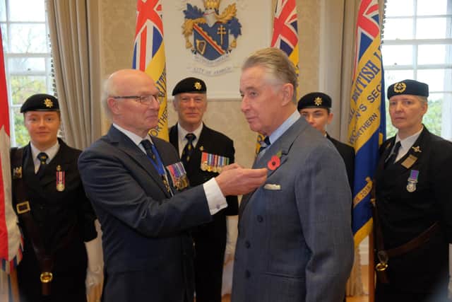 President of the Royal British Legion in Northern Ireland, Col Neil Salisbury (ret’d), pinning a poppy on Lord Lieutenant Lord Nicholas Caledon
