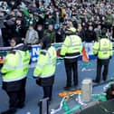 Police officers and stewards form a line to separate the fans following the Scottish Cup at Ibrox. (Photo by Steve Welsh/PA Wire)