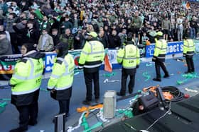 Police officers and stewards form a line to separate the fans following the Scottish Cup at Ibrox. (Photo by Steve Welsh/PA Wire)