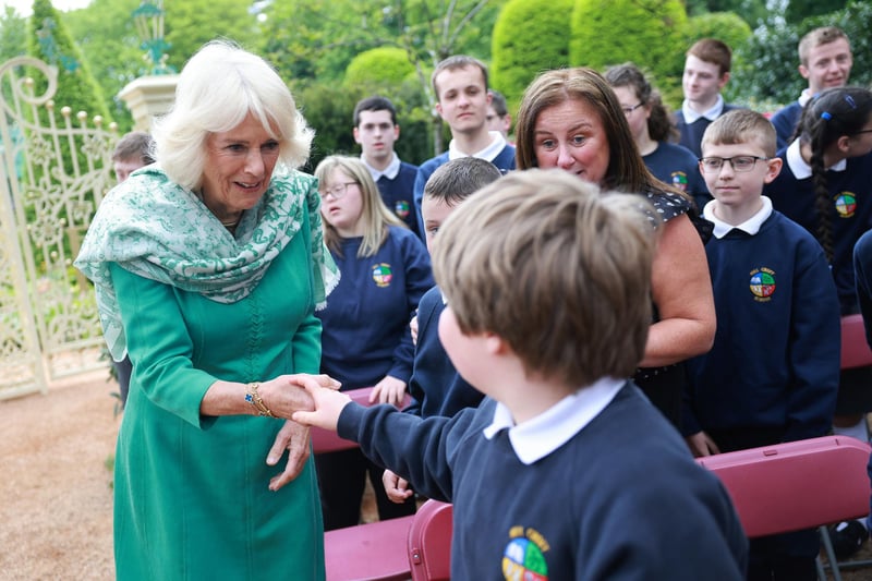 Queen Camilla greets school children during a visit to open the new Coronation Garden  in Newtownabbey