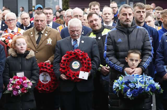 Charlie Butler (centre), and people from the local community take part in a minute's silence on Shankill Road in Belfast, during an event to mark the 30th anniversary of the Shankill bomb. Picture date: Saturday October 21, 2023. Photo: Peter Morrison/PA Wire