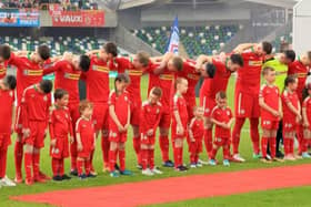 Cliftonville players bow their heads during the playing of the national anthem at Windsor Park in 2018. Photo - David Maginnis Pacemaker Press.