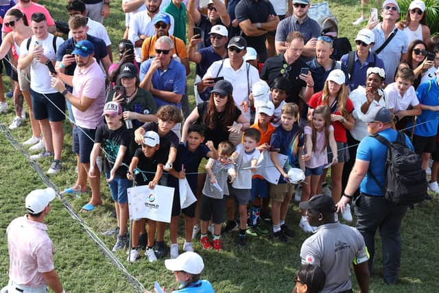 Spectators call out to Rory McIlroy as he leaves the 18th green during Day Three of the DP World Tour Championship on the Earth Course at Jumeirah Golf Estates