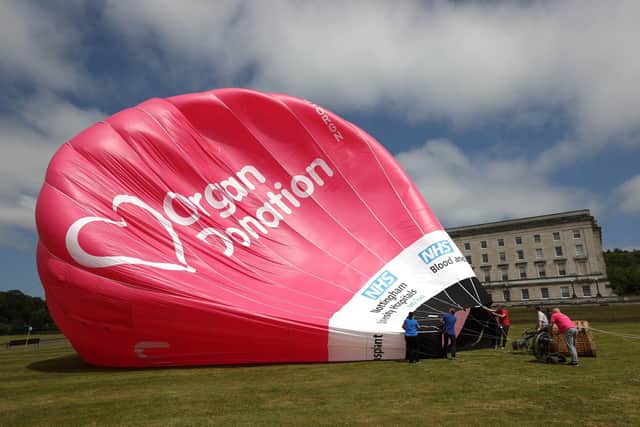 A hot air balloon preparing to take-off outside the Parliament Buildings in Stormont, ahead of the introduction of the Organ and Tissue Donation (Deemed Consent) legislation, known as 'Daithi's Law', named in honour of six-year-old Daithi Mac Gabhann from Belfast, who is waiting for a new heart