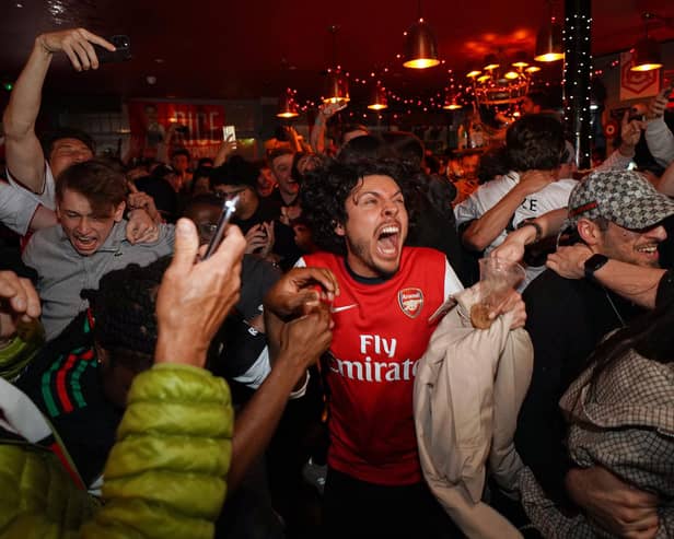 Arsenal supporters celebrate the club becoming Premier League champions. (Photo by AP Photo/Alberto Pezzali)