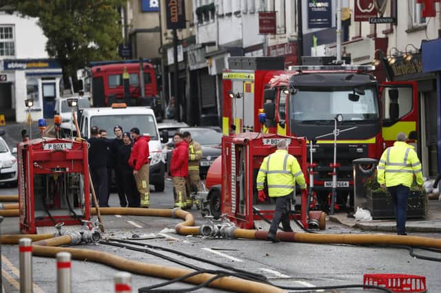Northern Ireland Fire and Rescue Service continue to pump water from flooded premises in Downpatrick town centre. Photo: Peter Morrison/PA Wire