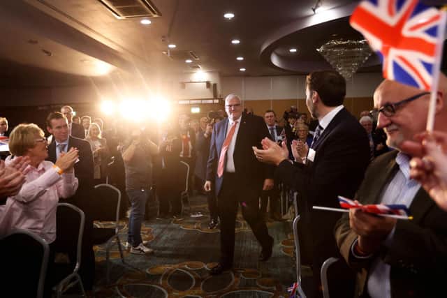Democratic Unionist Party leader Gavin Robinson MP arrives to a standing applause by delegates at the DUP party conference at the La Mon Hotel, Belfast. Photo: Peter Morrison/PA Wire