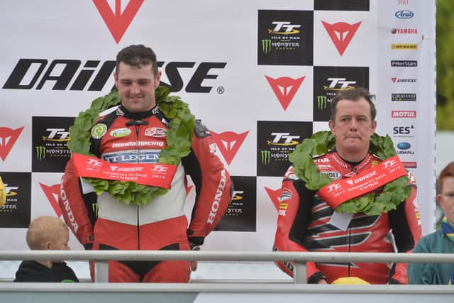 Michael Dunlop celebrates winning the Superbike TT in 2013 alongside his Honda TT Legends team-mate John McGuinness, who was third