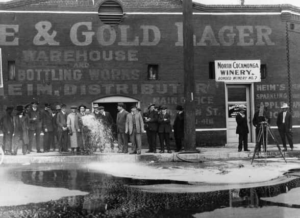 February 1920:  33,100 gallons of wine being flushed into the gutter outside the North Cucamonga Winery in Los Angeles at the start of the National Prohibition on intoxicating drink.  (Photo by Topical Press Agency/Getty Images)