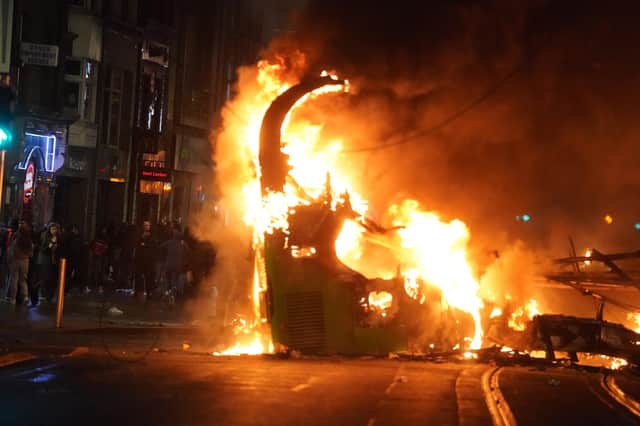 A bus on fire on O'Connell Street in Dublin city centre after violent scenes unfolded on Thursday night. Photo: Brian Lawless/PA Wire