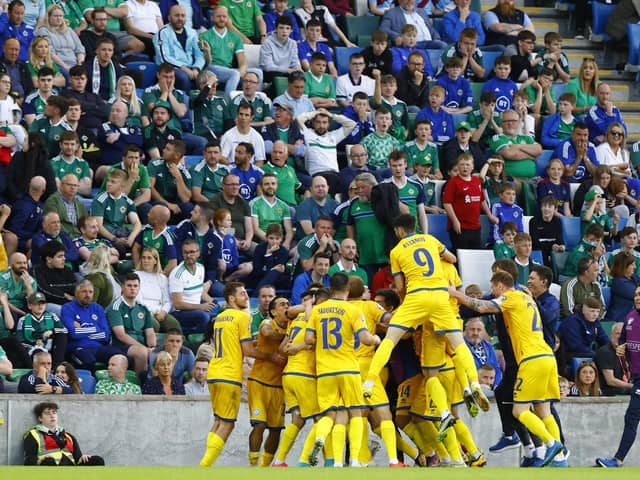 Stunned Northern Ireland fans look on as Kazakhstan players celebrate a late winner in Belfast during the Euro 2024 qualifiers