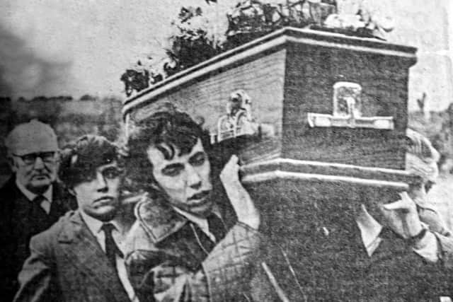 Alan Freeburn son of Robert Freeburn, one of the victims of the Kingsmill Massacre, carrying the coffin of his father into Kingsmills Presbyterian Church for the funeral service.