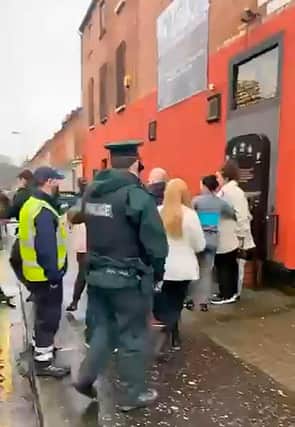 Police make the arrest in the Ormeau Road area of Belfast after officers intervened at the memorial marking the 29th anniversary of a loyalist massacre at the Sean Graham's bookmakers shop.