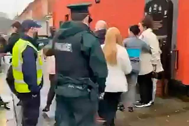 Police make the arrest in the Ormeau Road area of Belfast after officers intervened at the memorial marking the 29th anniversary of a loyalist massacre at the Sean Graham's bookmakers shop.