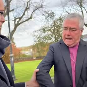 Enoch Burke pictured grabbing the archbishop during the encounter