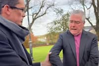Enoch Burke pictured grabbing the archbishop during the encounter