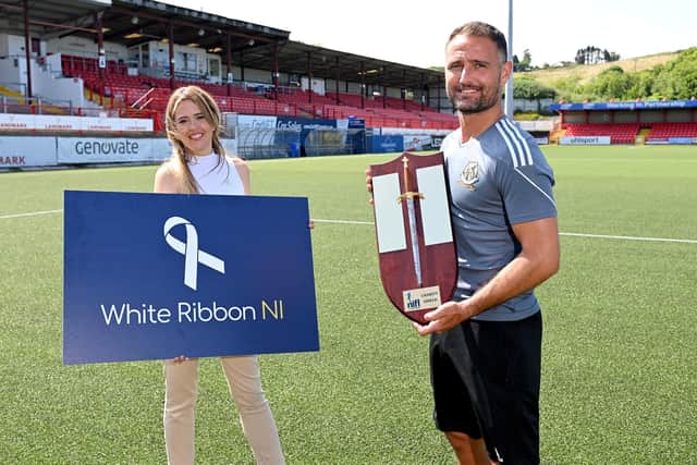 Tahnee McCorry from White Ribbon NI pictured with Crusaders goalkeeper Johnny Tuffey ahead of this year's Charity Shield match against Larne