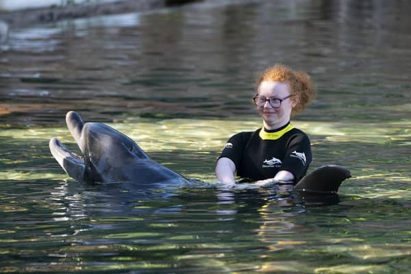 Emma Huey, 14, from Ballymoney in Co Antrim swims with a dolphin during the Dreamflight visit to Discovery Cove in Orlando, Florida. Picture: Kirsty O'Connor/PA Wire