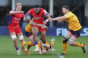 Joe Cokanasiga of Bath is tackled by Jacob Stockdale (L), Nath Doak and Iain Henderson (R) during the Investec Champions Cup match between Bath and Ulster at the Recreation Ground on December 09, 2023 in Bath, England. (Photo by David Rogers/Getty Images)