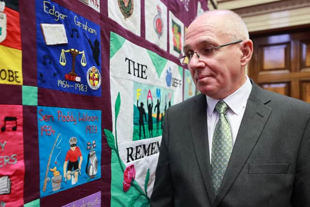 Paul Wilson, the son of Paddy Wilson, stands beside a memorial quilt created by the South East Fermanagh Foundation (SEFF) during an event at Stormont marking the 50th anniversary of the murder of his father SDLP senator Paddy Wilson. Mr Wilson was killed by the loyalist Ulster Freedom Fighters (UFF) on June 26 1973. 
Photo: Liam McBurney/PA Wire