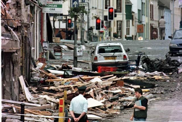 A Royal Ulster Constabulary officer looking at the damage caused by a bomb explosion in Market Street, Omagh. A decision on whether to order a public inquiry into the 1998 Omagh bombing is expected to be announced later by the Government. Issue date: Thursday February 2, 2023.