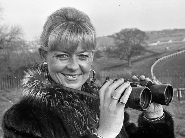 Pictured at the Harp National in Downpatrick in February 1992 is Iris Duff from Cultra, Co Down, who got herself into a good position to enjoy the spectacle during the races at Downpatrick. The star of the national was Desert Orchid. The News Letter reported that he “strutted, proud and tall, around the race track to loud and eager applause, looking every bit the champion”. Fans had turned out to get a close look at the grey who had retired from racing two years previously. Picture: News Letter archives