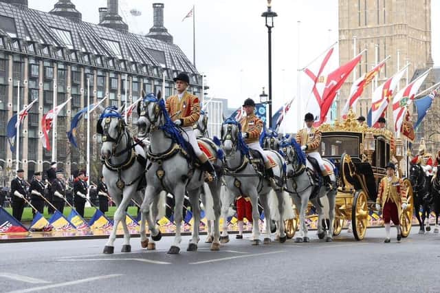 ​Royal British Legion standard bearers including Sir Knight David Cuddy (far left) line up in formation as the Gold State Coach carrying the King and Queen passes through Parliament Square