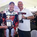 Davey Todd receives the Robert Dunlop Trophy as Man of the Meetng at the 2024 Briggs Equipment North West 200 from Event Director Mervyn Whyte and Gary Clements of Briggs Equipment