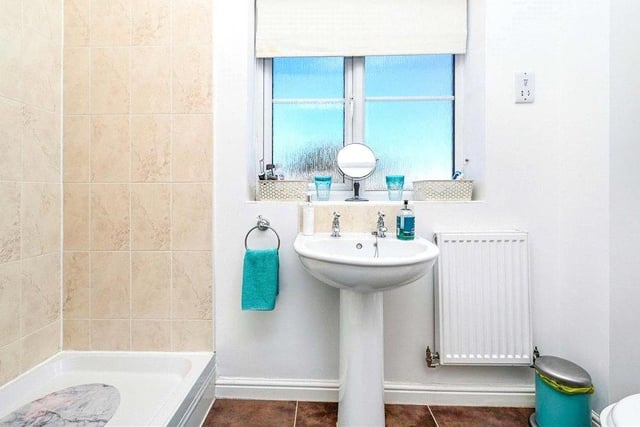The en suite to the master bedroom comprises a fully tiled shower enclosure, wash hand basin, low-flush WC, extractor fan and uPVC double-glazed window to the front of the £220,000 property.