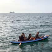 Three migrants who were attempting to cross The English Channel from France to Britain are seen as they drift in an inflatable canoe off the French coast at Calais on August 4, 2018, before being rescued by lifeguards of Les Sauveteurs en Mer (SNSM). (Photo by STR / AFP) (Photo credit: STR/AFP via Getty Images)