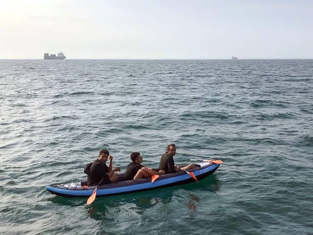 Three migrants who were attempting to cross The English Channel from France to Britain are seen as they drift in an inflatable canoe off the French coast at Calais on August 4, 2018, before being rescued by lifeguards of Les Sauveteurs en Mer (SNSM). (Photo by STR / AFP) (Photo credit: STR/AFP via Getty Images)