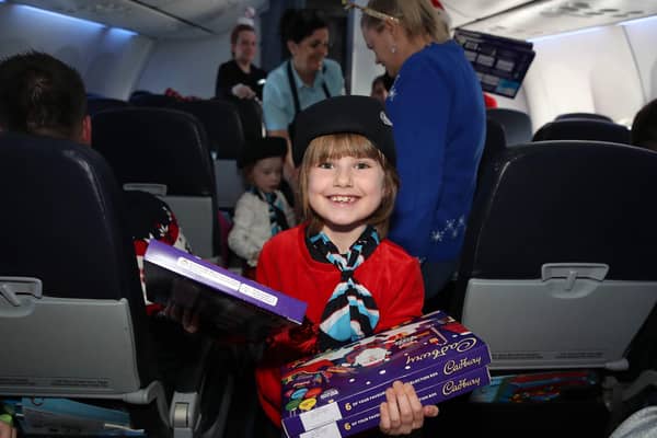 Jenny Ellenbogen from Bangor helps hand out the selection boxes on the plane on her way to see Santa in Lapland. NI children, parents, caregivers, and medical professionals boarded a life-changing flight by NI Children to Lapland Trust for an unforgettable day. Photograph by Declan Roughan dvrphoto@me.com