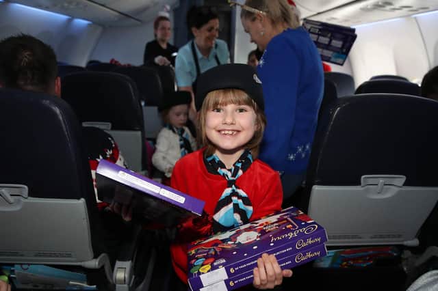 Jenny Ellenbogen from Bangor helps hand out the selection boxes on the plane on her way to see Santa in Lapland. NI children, parents, caregivers, and medical professionals boarded a life-changing flight by NI Children to Lapland Trust for an unforgettable day. Photograph by Declan Roughan dvrphoto@me.com