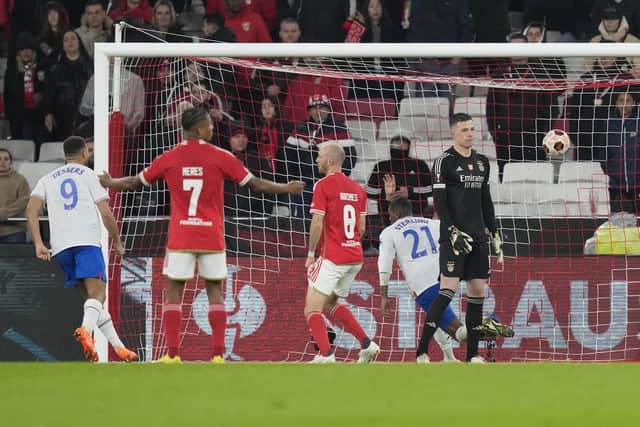 Benfica's goalkeeper Anatoliy Trubin, right, reacts as Rangers' Dujon Sterling, back, celebrates scoring his side's second goal during the Europa League round of 16, first leg, at the Luz stadium in Lisbon