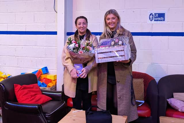Tracey Maea is presented with her hamper and flowers by Claire Murphy from Henderson Group who thanked her for all she does at the Newtownards Community Foodbank.