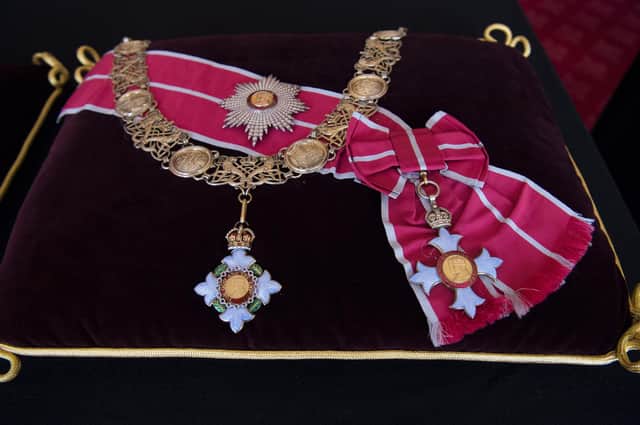 The British Empire Collar and Grand Masters Badge, and the British Empire Breast Star and Badge sewn onto a cushion in St James's Palace, London.