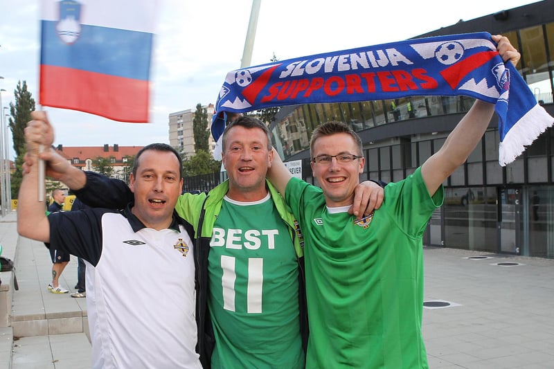 Northern Ireland fans pose for a photo outside the stadium