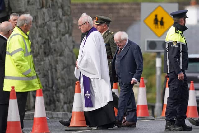 Irish President Michael D. Higgins (centre)arrives for the funeral mass of James Monaghan and and his mother Catherine O'Donnell at St Michael's Church, Creeslough.