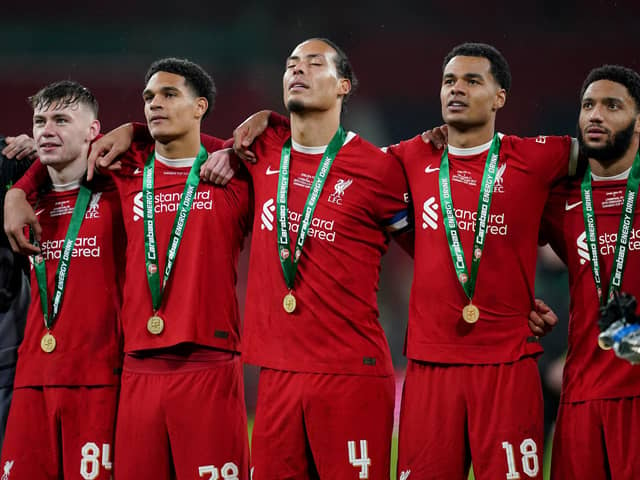 Liverpool's Conor Bradley, Jarell Quansah Virgil van Dijk, Cody Gakpo and Joe Gomez stand in front of their fans as they sign You'll Never Walk Alone after the Carabao Cup final at Wembley Stadium, London. PIC: Adam Davy/PA Wire.