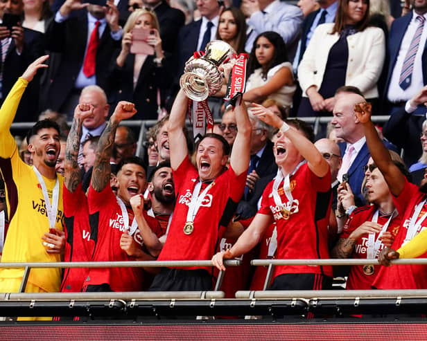 Northern Ireland's Jonny Evans lifts the FA Cup trophy after success at Wembley on Saturday for Manchester United against Manchester City. (Photo by John Walton/PA Wire)